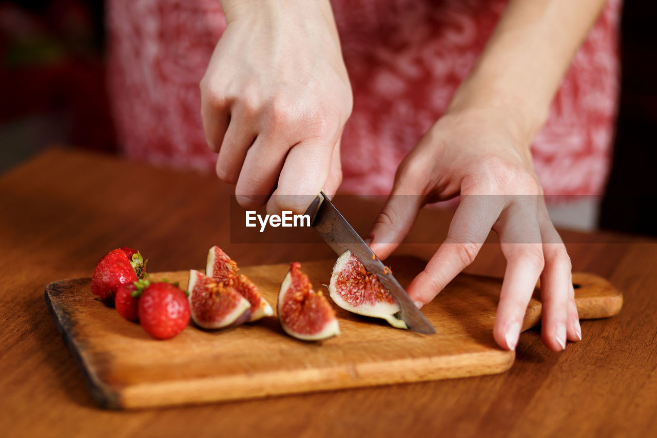 The tasty fruits such as strawberry and fig that are cut on slices