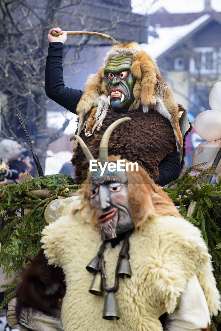 Public and traditional parade with funny masks at carnival