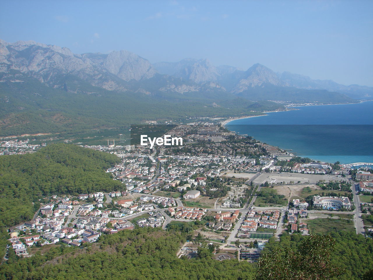 High angle view of townscape by sea against sky