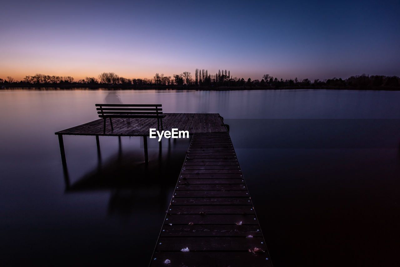 PIER ON LAKE DURING SUNSET