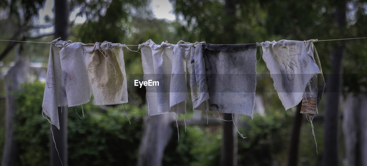 CLOSE-UP OF CLOTHES HANGING ON ROPE