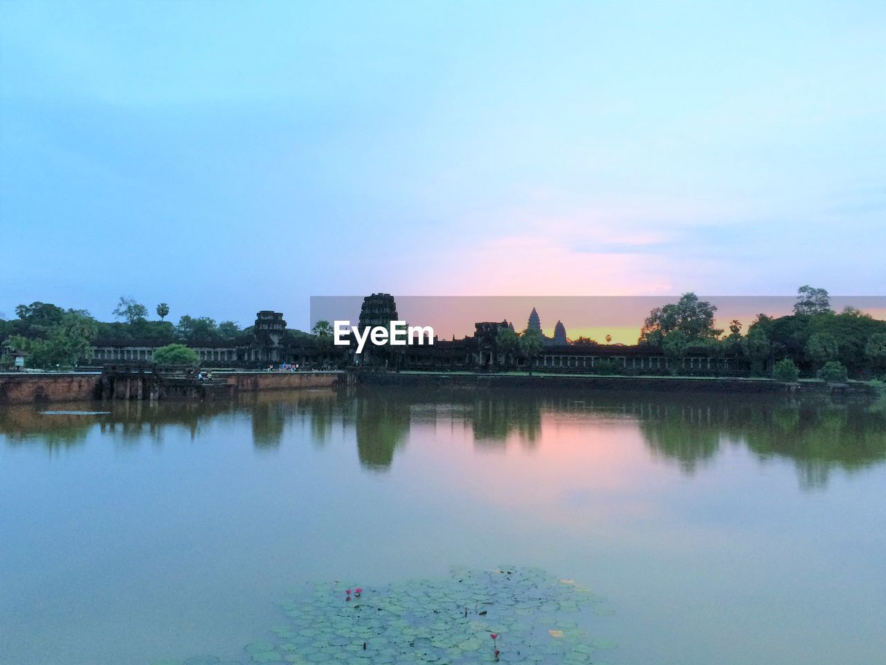 Scenic view of lake against sky at sunset