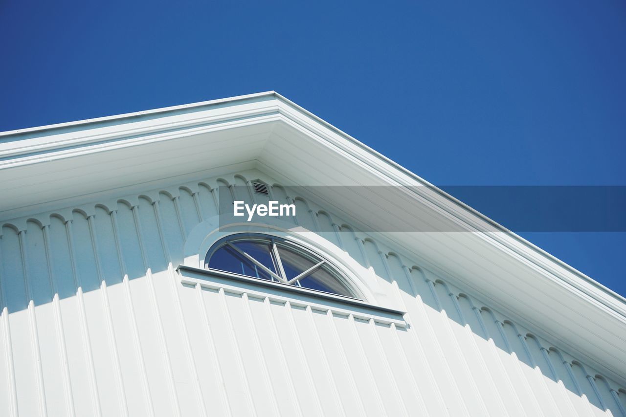 Low angle view of building against clear blue sky