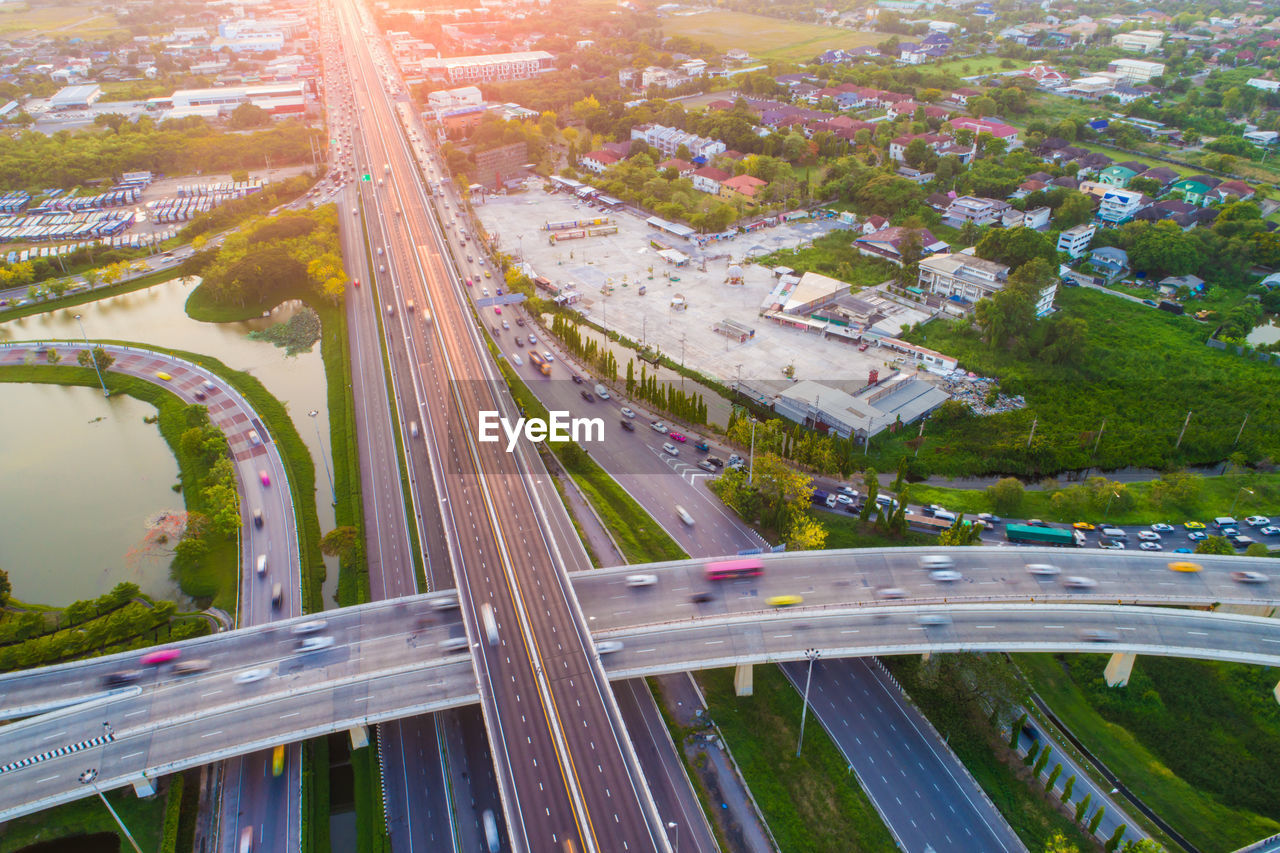 HIGH ANGLE VIEW OF ELEVATED ROAD LEADING TOWARDS CITY