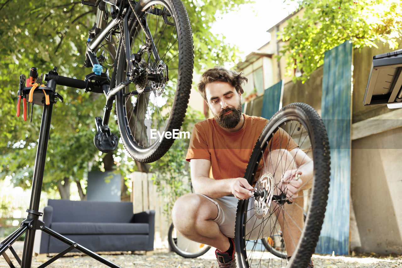 low angle view of man riding bicycle at park