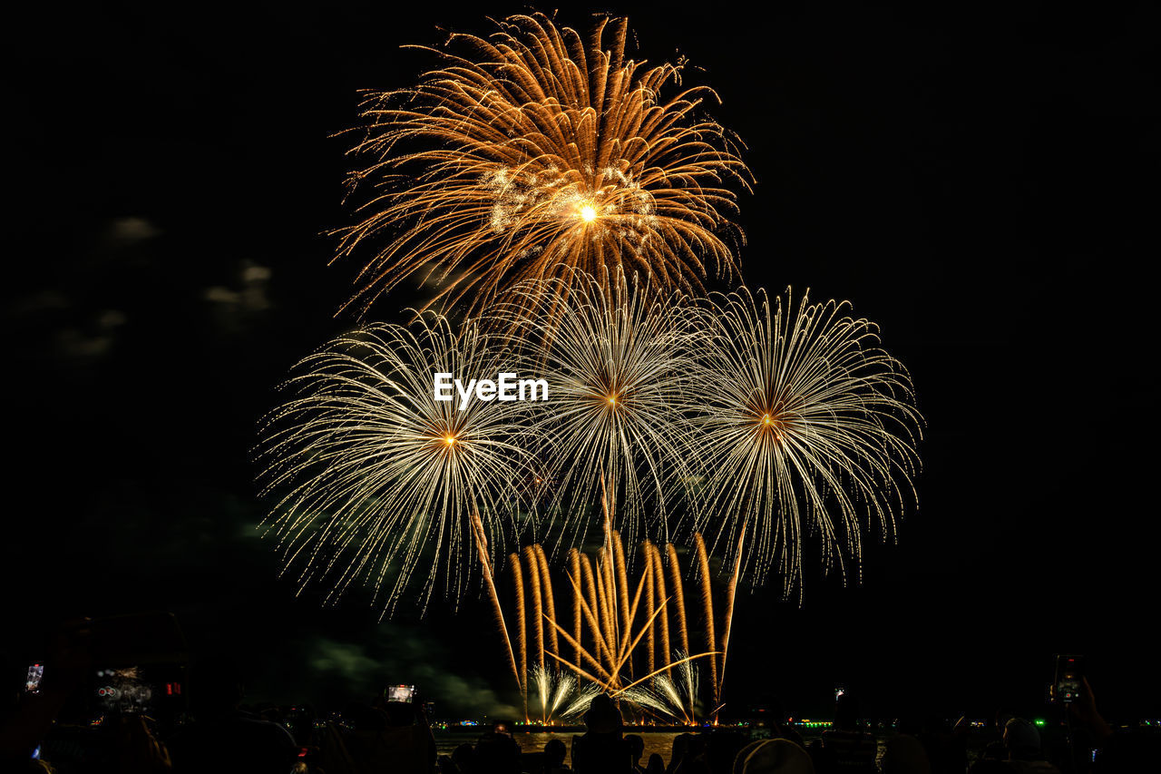 Fireworks show under defocus or blur concepts with isolated black background.