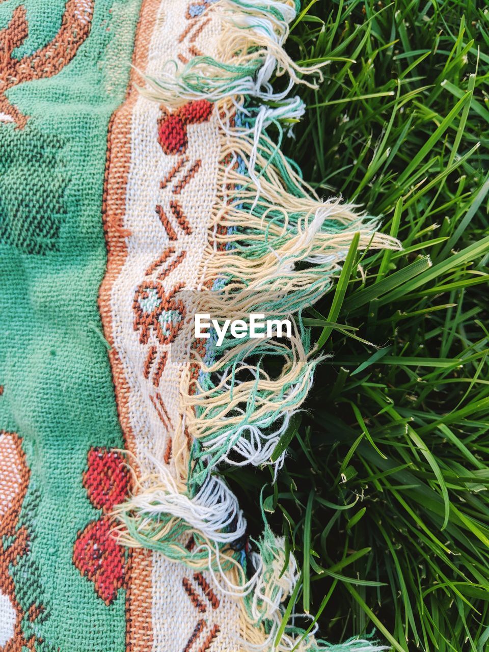 High angle view of blanket on grassy field