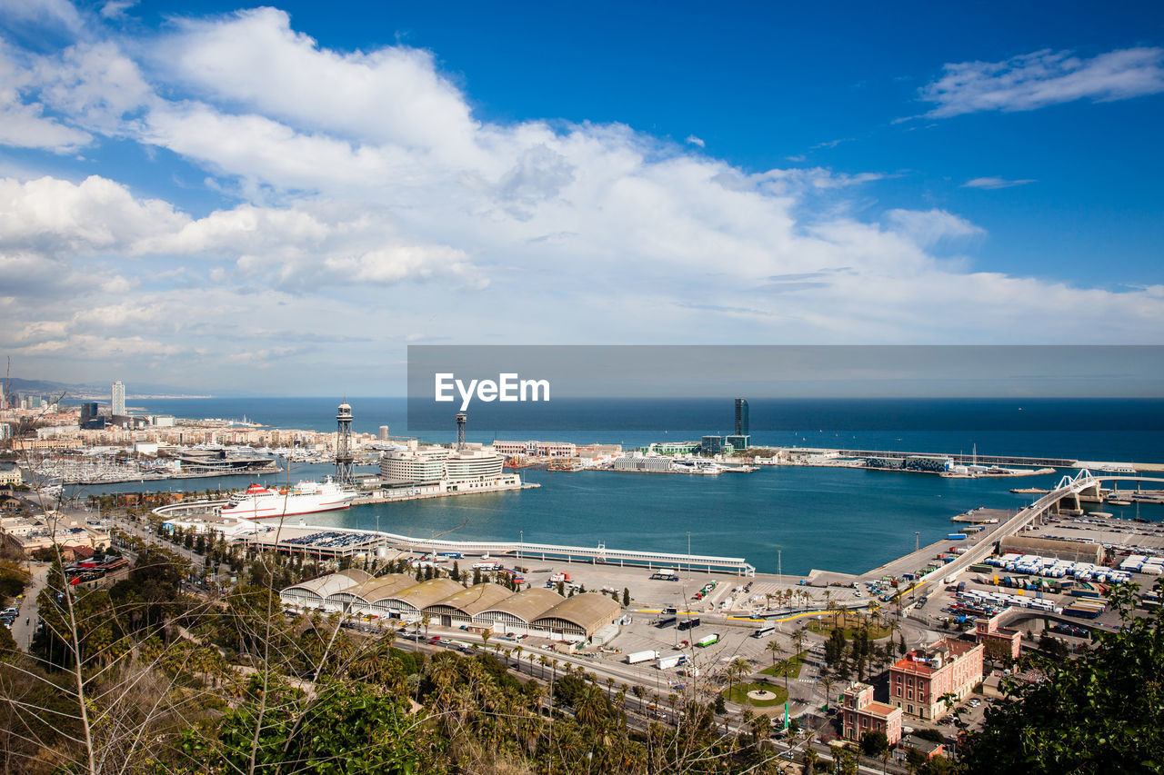 HIGH ANGLE VIEW OF HARBOR AND BUILDINGS IN CITY