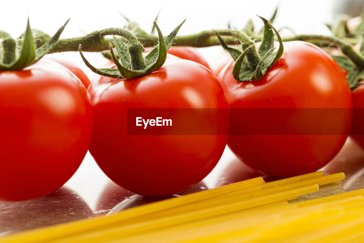 CLOSE-UP OF TOMATOES IN CONTAINER