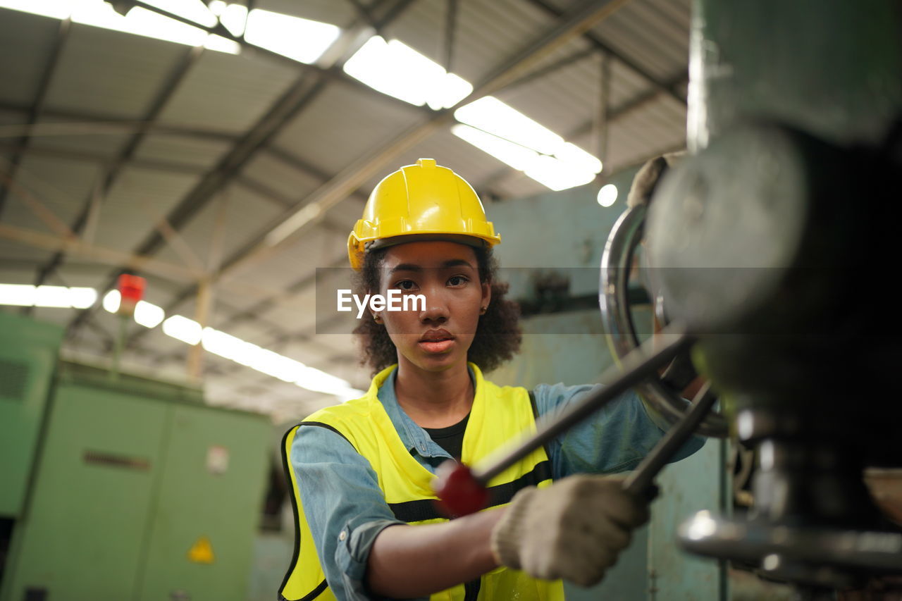 side view of boy standing in factory