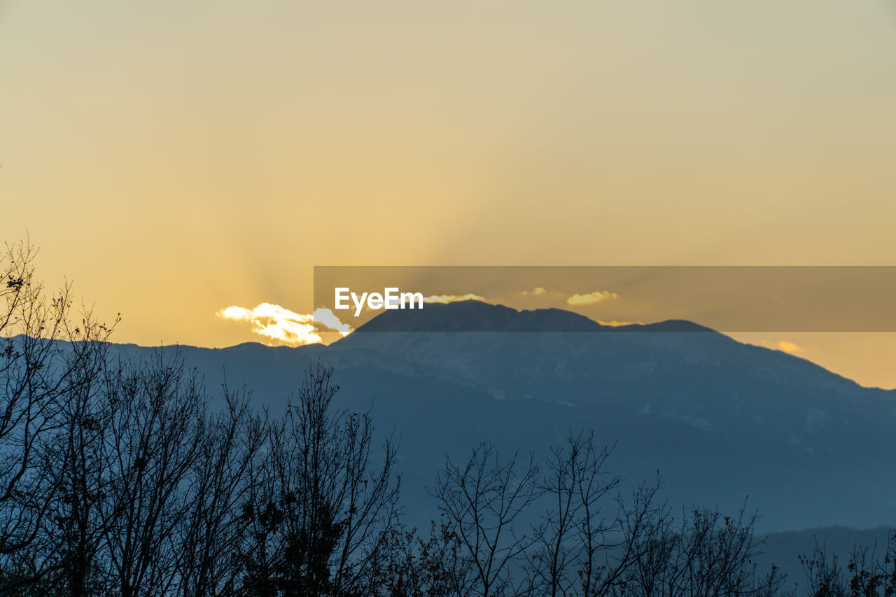 Scenic view of snowcapped mountains against sky during sunset