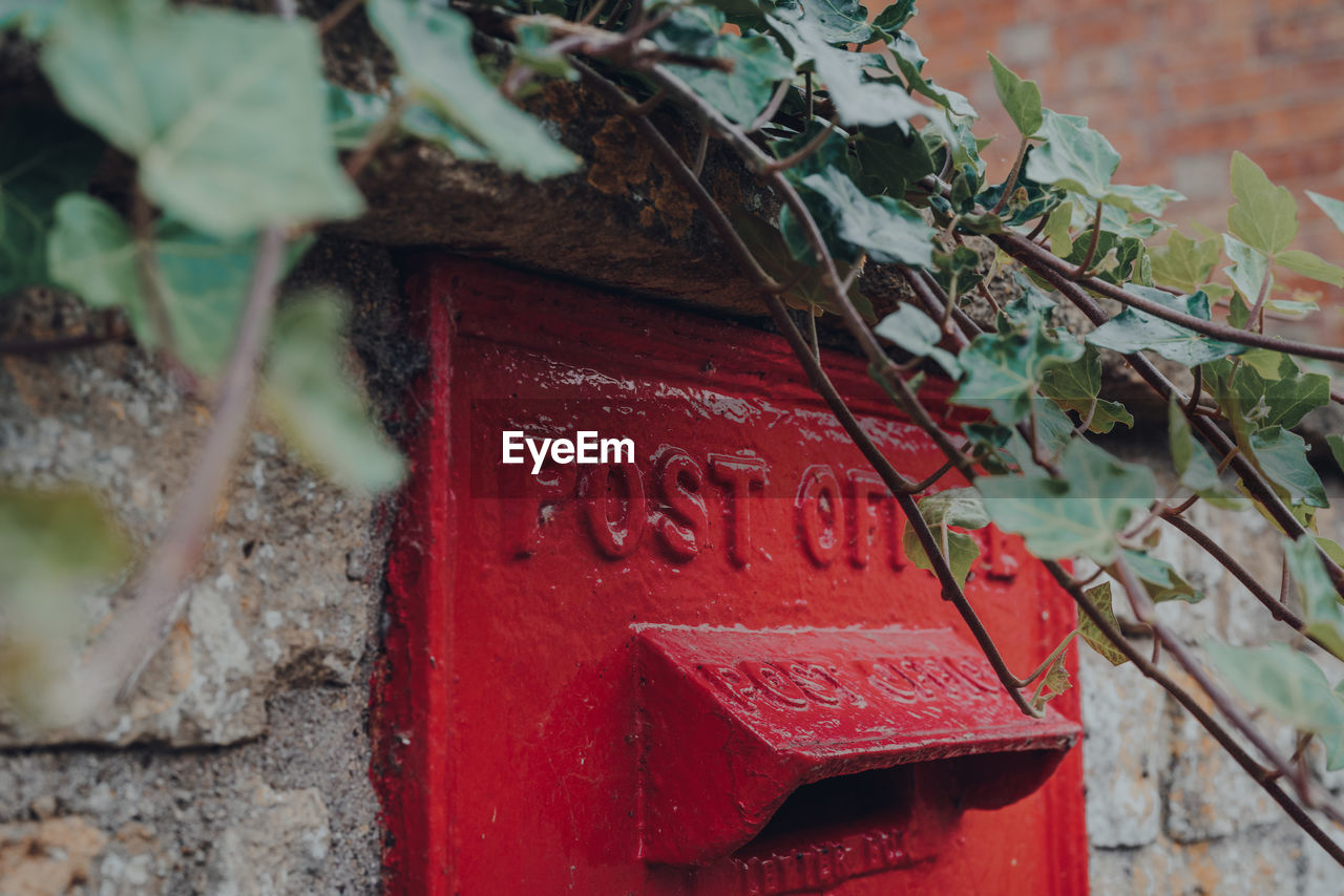 CLOSE-UP OF TEXT ON OLD RED MAILBOX