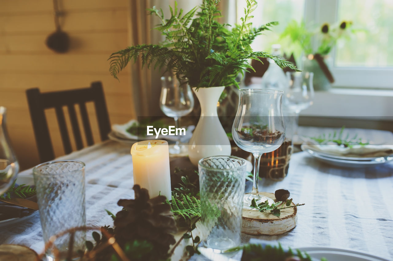 POTTED PLANT ON TABLE IN GLASS