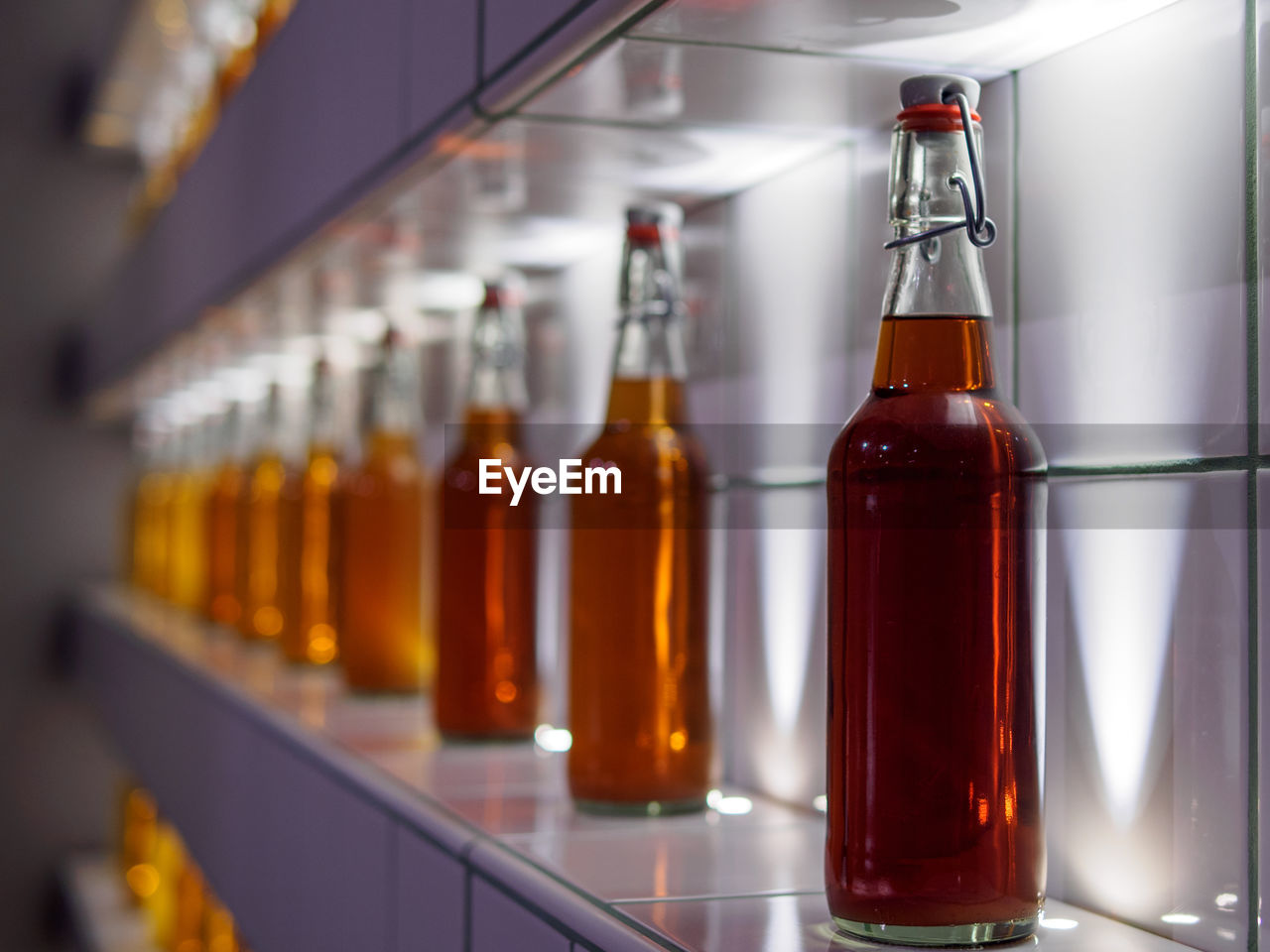 Close-up of alcohol bottles arranged on shelf