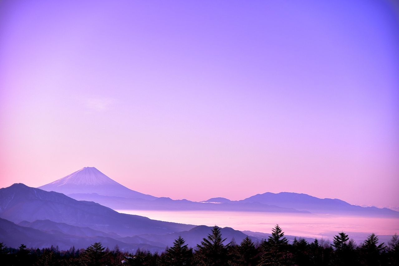 Scenic view of mountains against sky at sunset