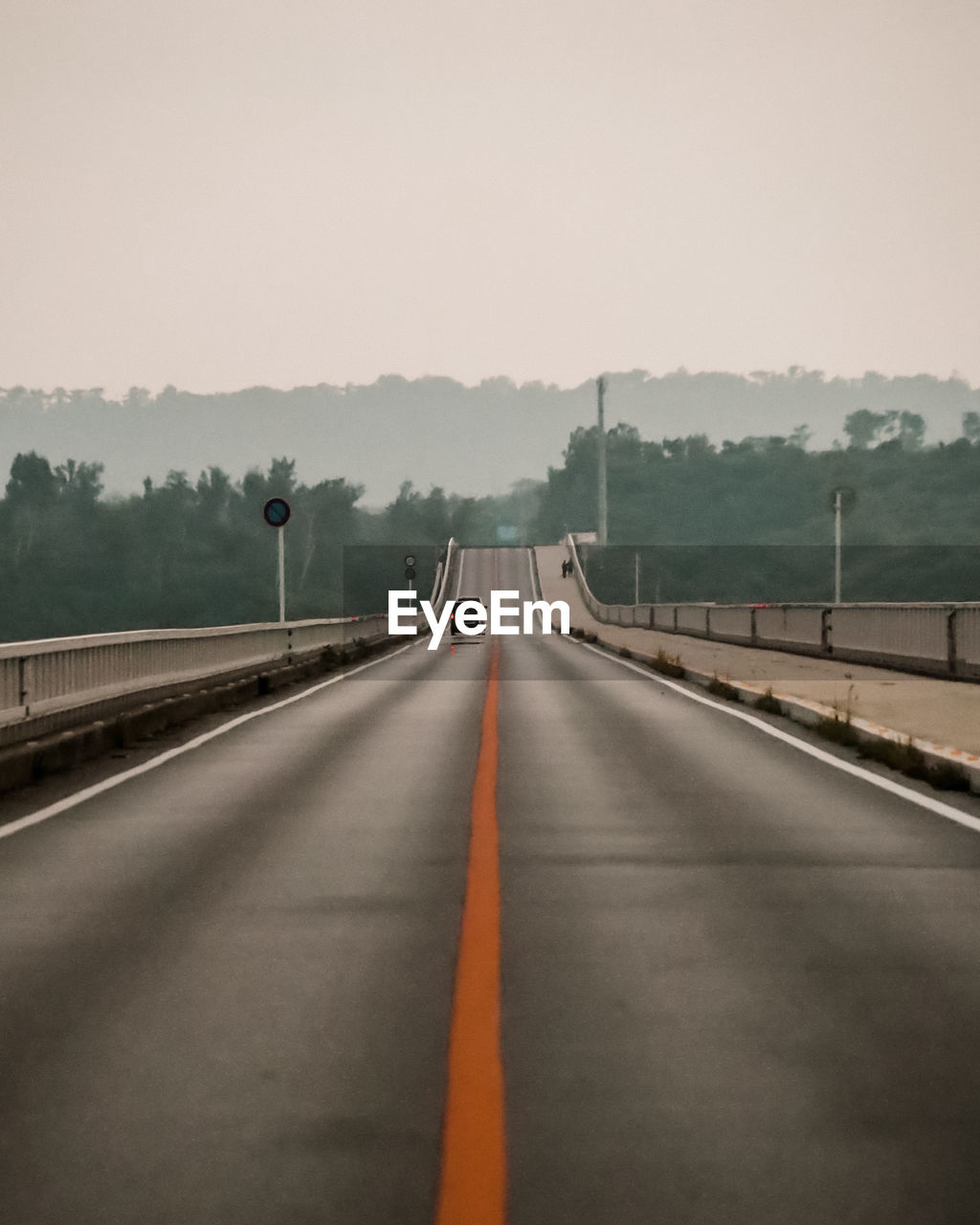 VIEW OF HIGHWAY AND BRIDGE AGAINST SKY