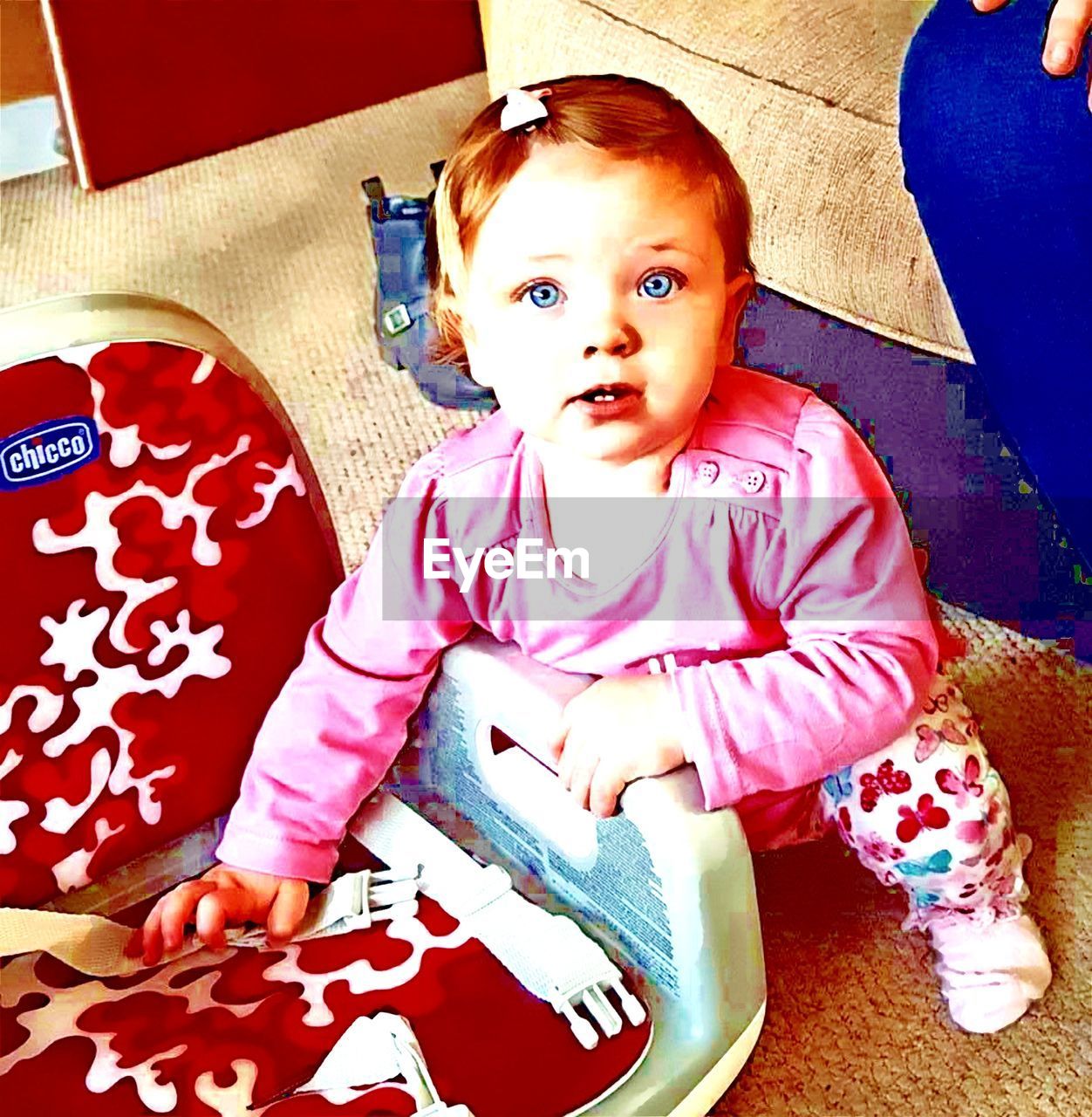 PORTRAIT OF CUTE BABY GIRL SITTING IN KITCHEN