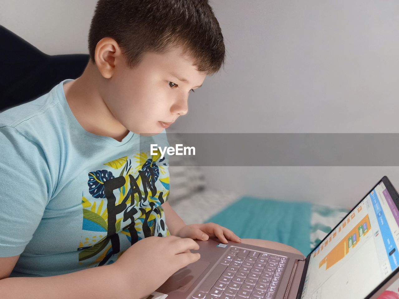 Boy using laptop at home