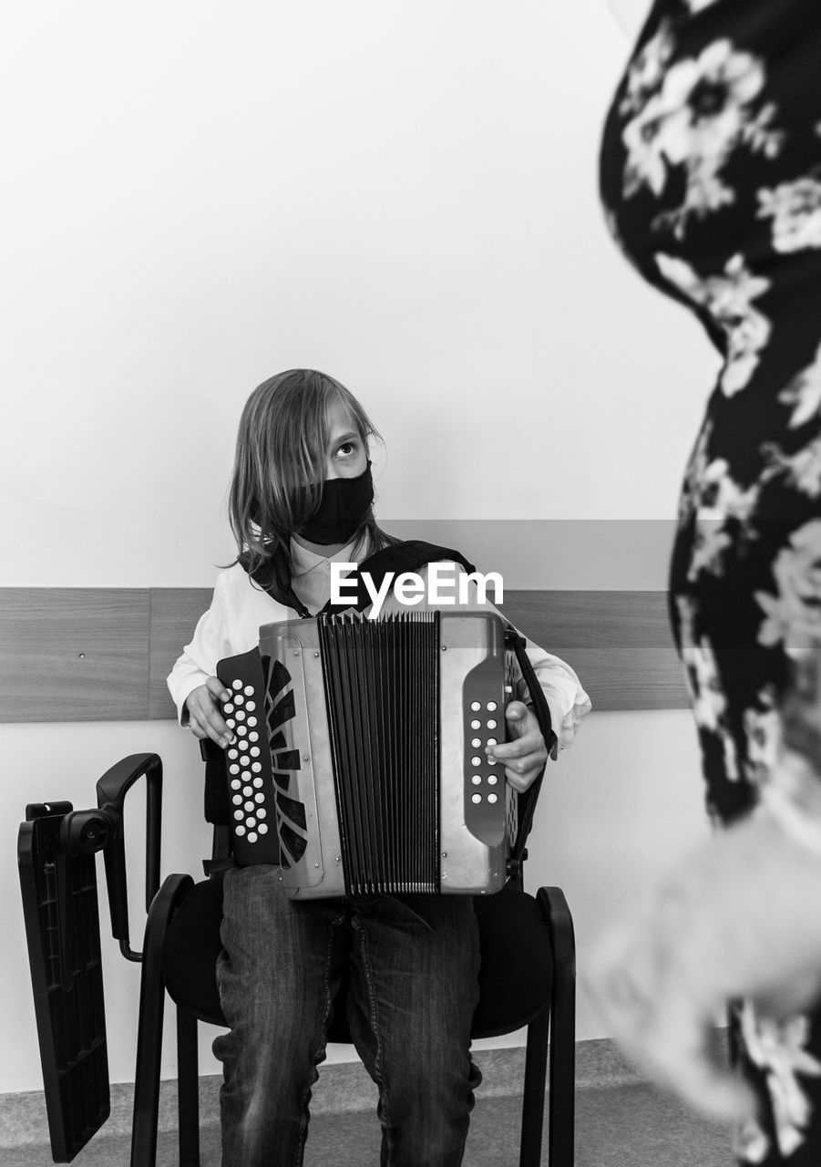 Portrait of a boy in accordion lesson