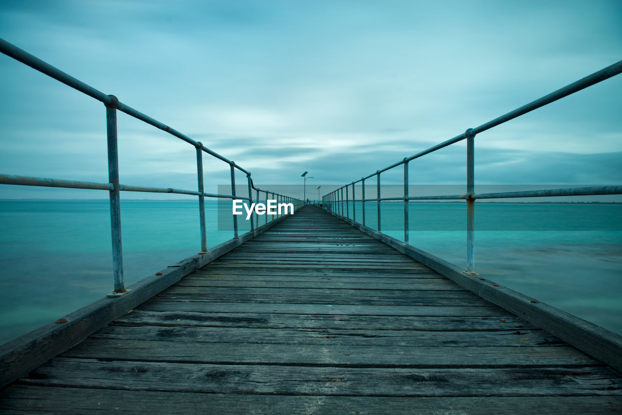 Pier over sea against sky