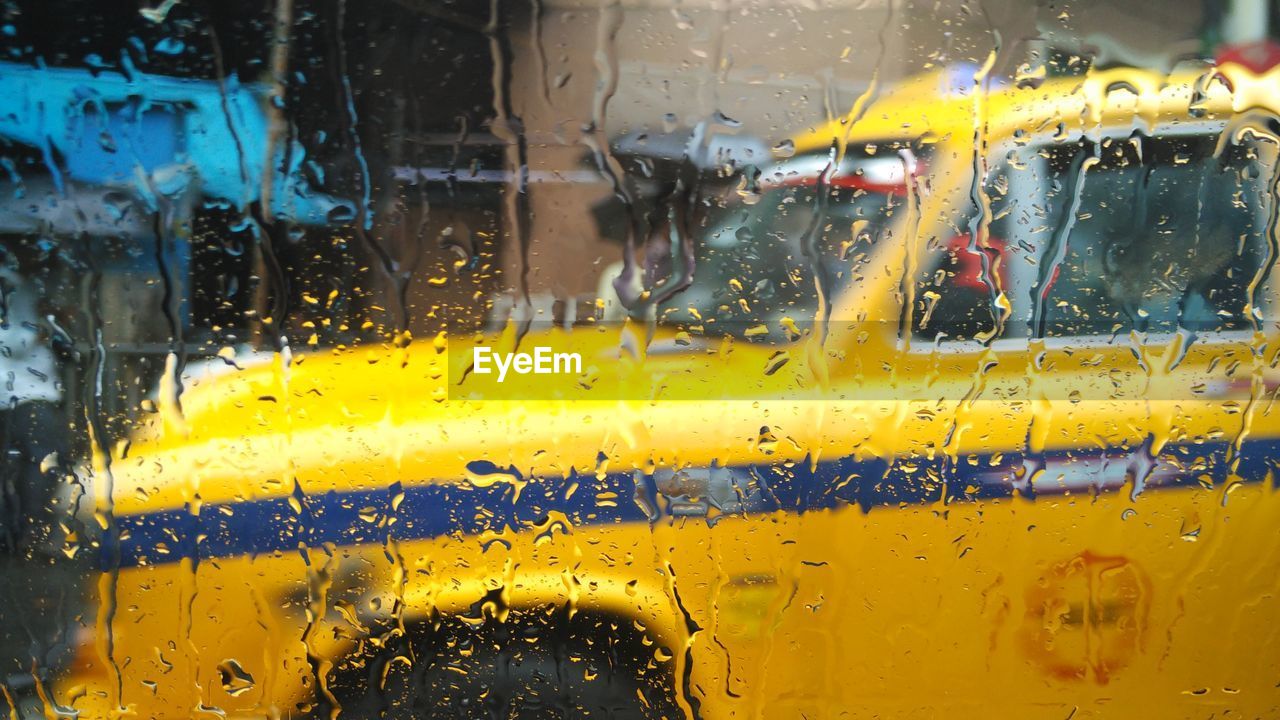 Taxi seen through wet car window