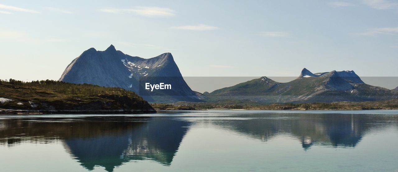 Scenic view of lake and mountains against sky