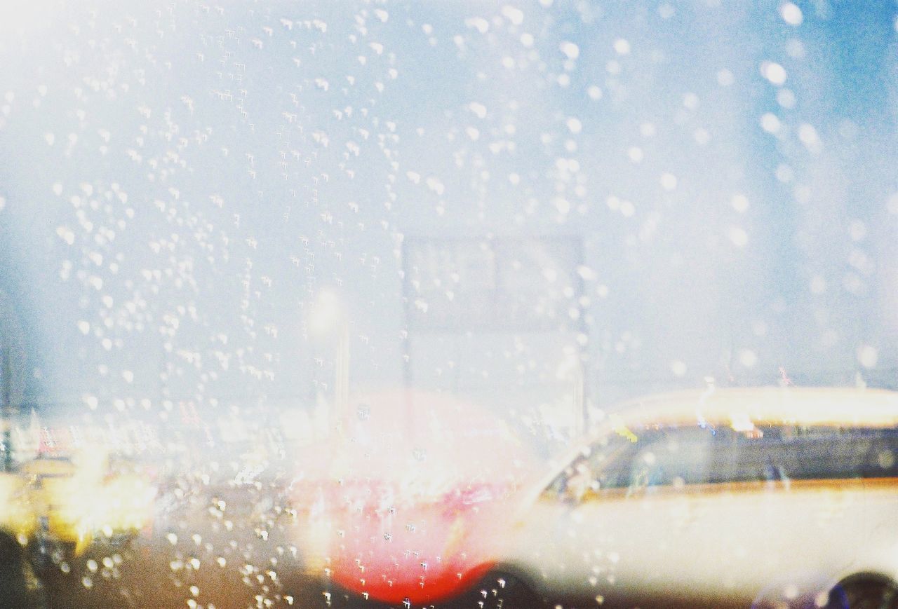 Close-up of wet car window in rainy season