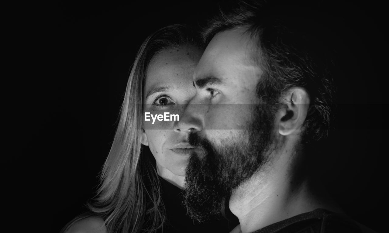 Portrait of man and woman on black background