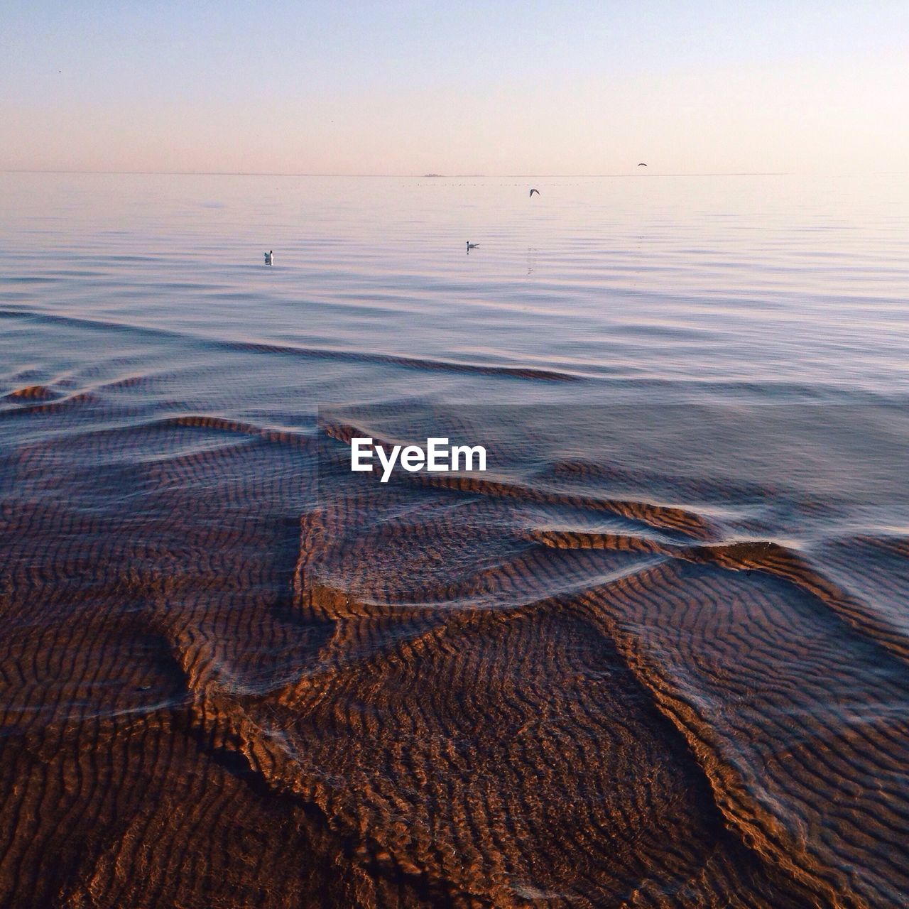 Scenic view of sea against sky at sunset