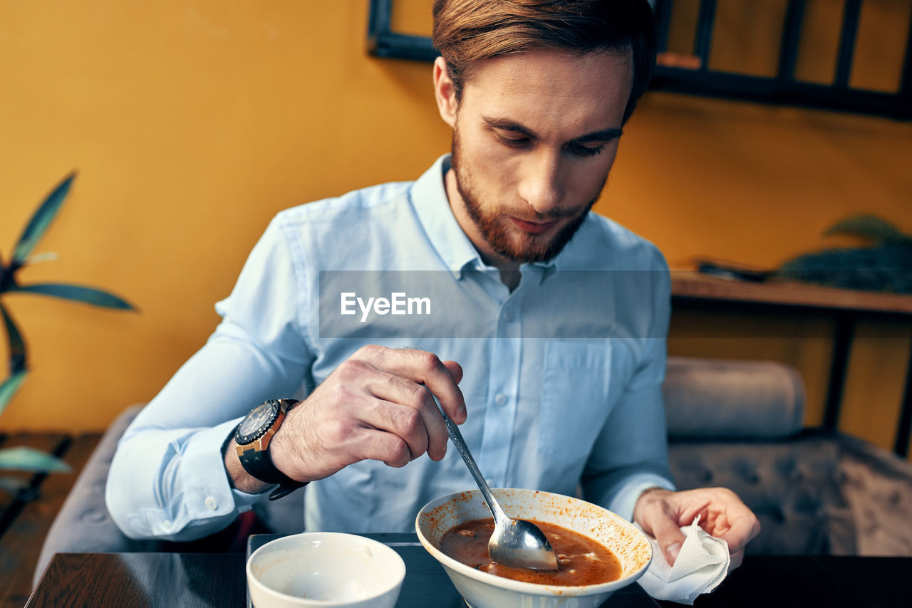 Midsection of man holding ice cream