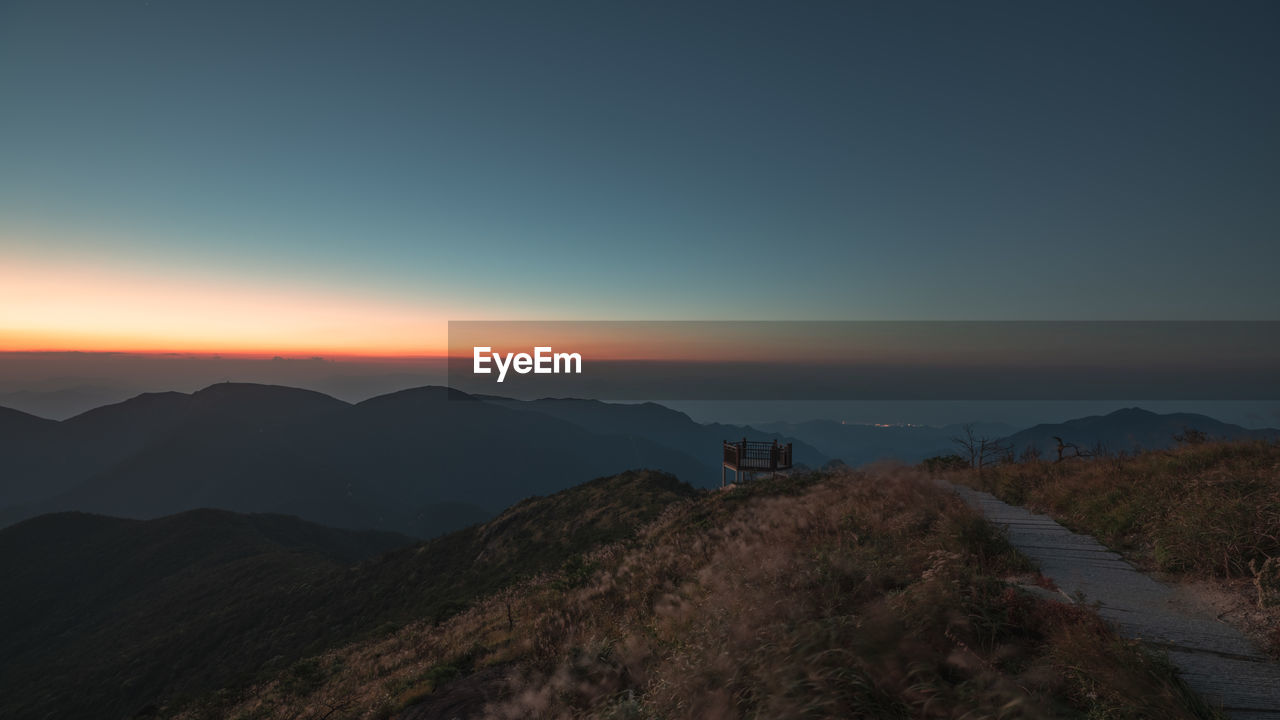 Scenic view of mountains against sky during sunset