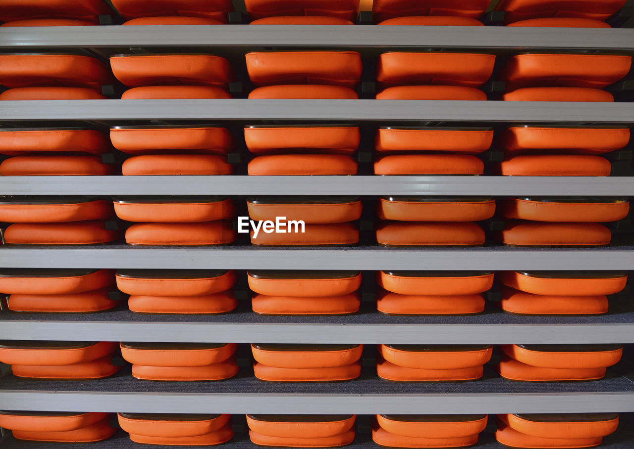 Full frame shot of orange trays in shelf