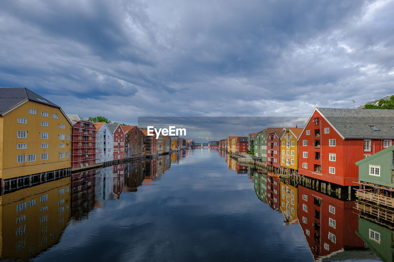 Illuminated buildings in city against sky