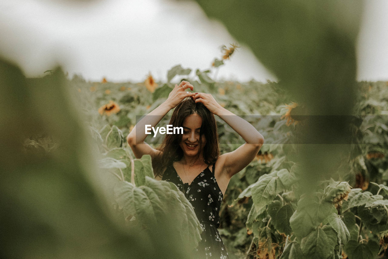 Young woman standing at sunflower farm