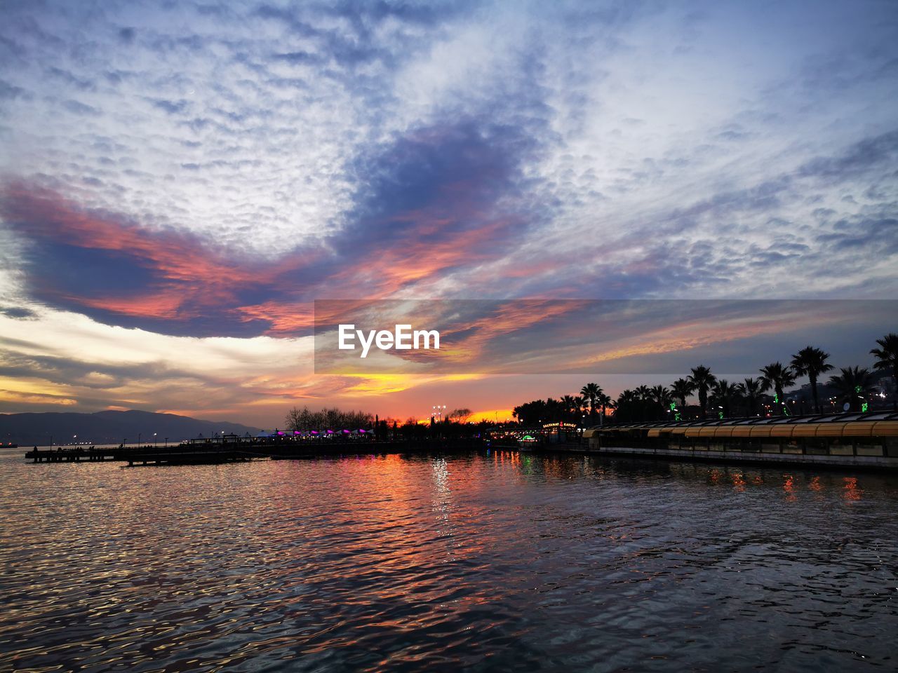 SCENIC VIEW OF LAKE AGAINST DRAMATIC SKY