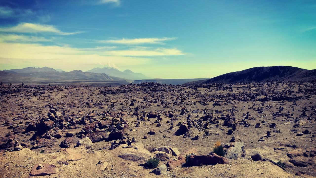 Barren landscape against blue sky