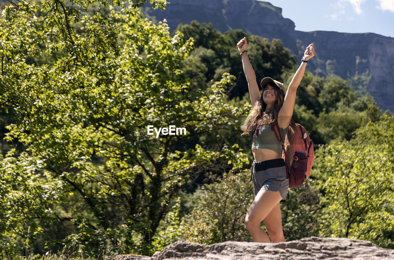 Mountaineer woman raising her arms happy