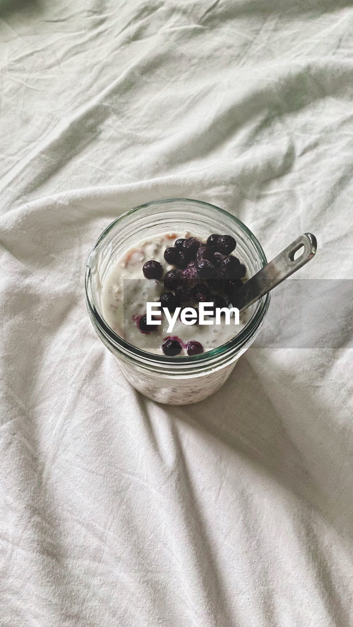 food and drink, food, healthy eating, wellbeing, fruit, eating utensil, freshness, high angle view, spoon, textile, berry, kitchen utensil, indoors, bowl, bed, breakfast, dairy, no people, linen, meal, furniture, sweet food, studio shot, tablecloth, blueberry, produce, yogurt, dessert, refreshment, still life
