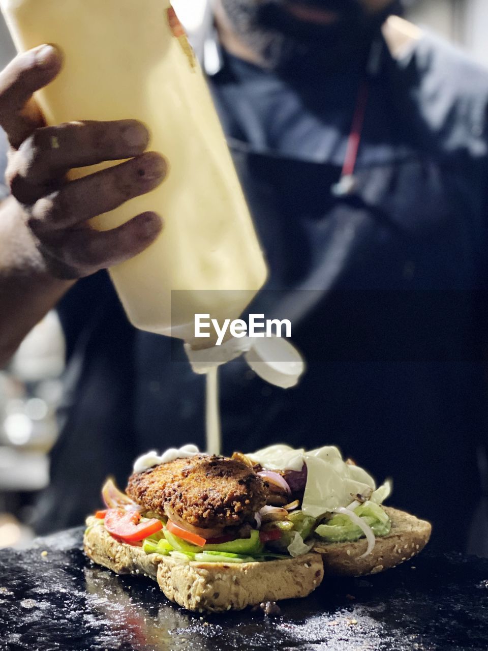 cropped hand of woman holding food