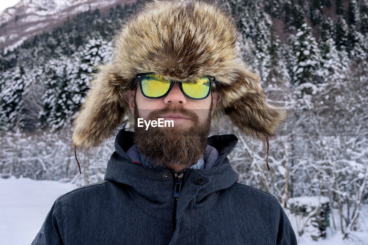 Portrait of man wearing sunglasses during winter