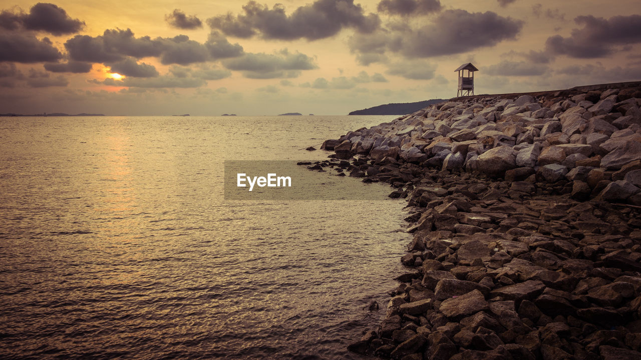 STACK OF ROCKS ON SHORE AGAINST SKY