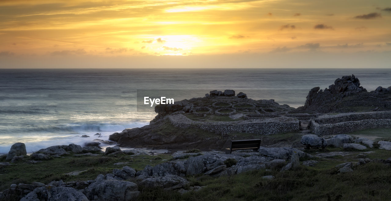 Bench on the coast with wonderful views of ancient ruins