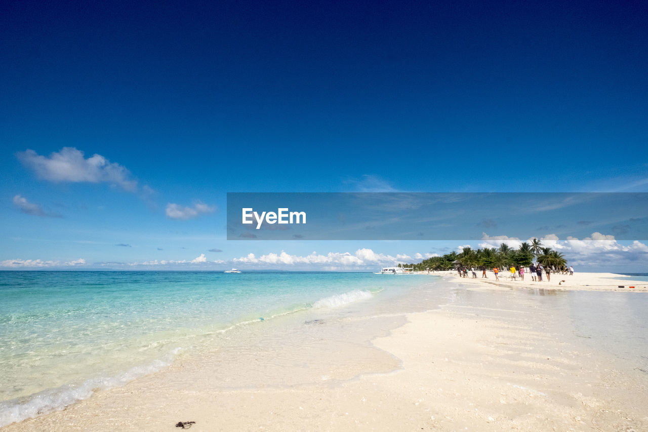 View of beach against blue sky