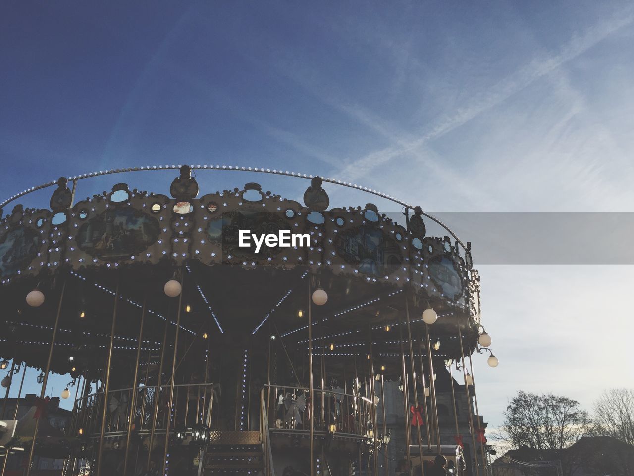 LOW ANGLE VIEW OF CAROUSEL AGAINST CLEAR SKY
