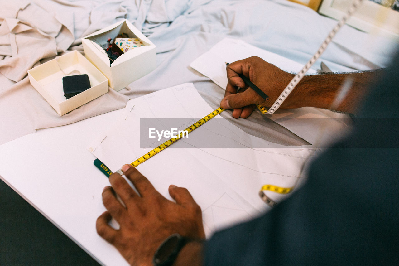 High angle view of man measuring