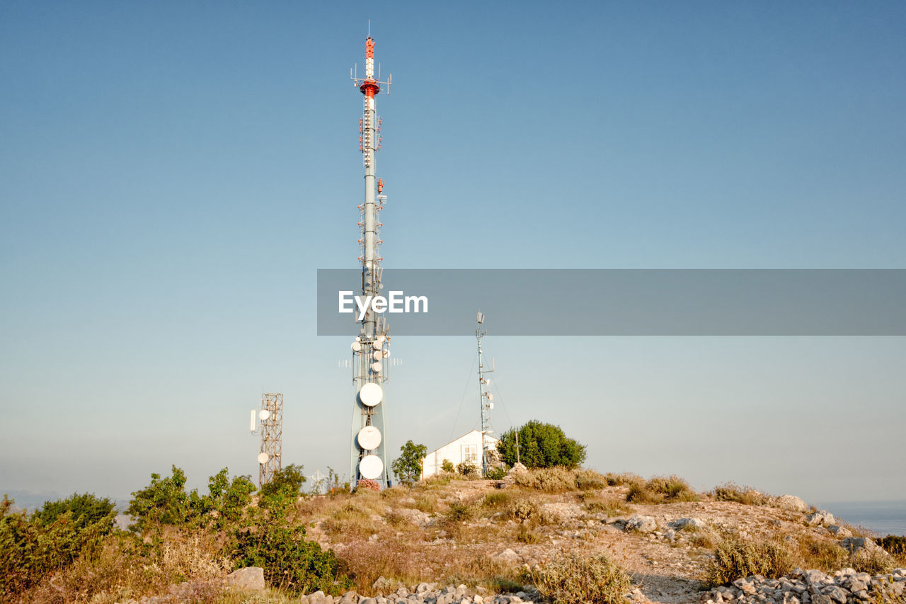 Low angle view of communications tower against sky