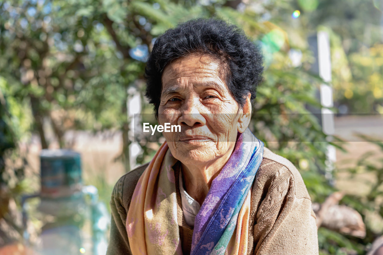 Close-up of old asian woman face with wrinkles elderly senior smiling happiness,