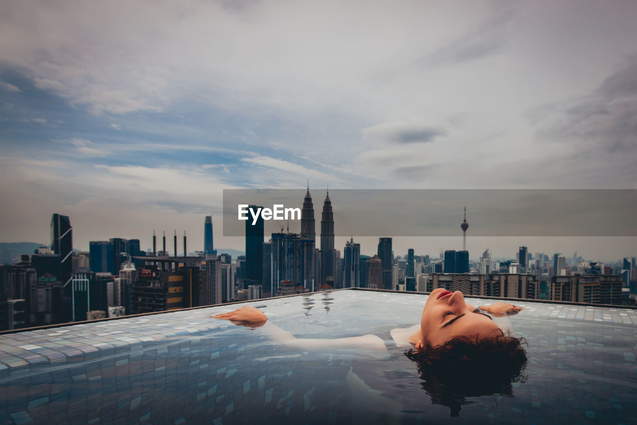 Woman swimming in infinity pool