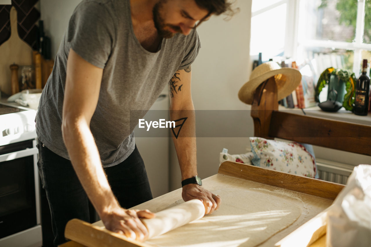 Man rolling dough