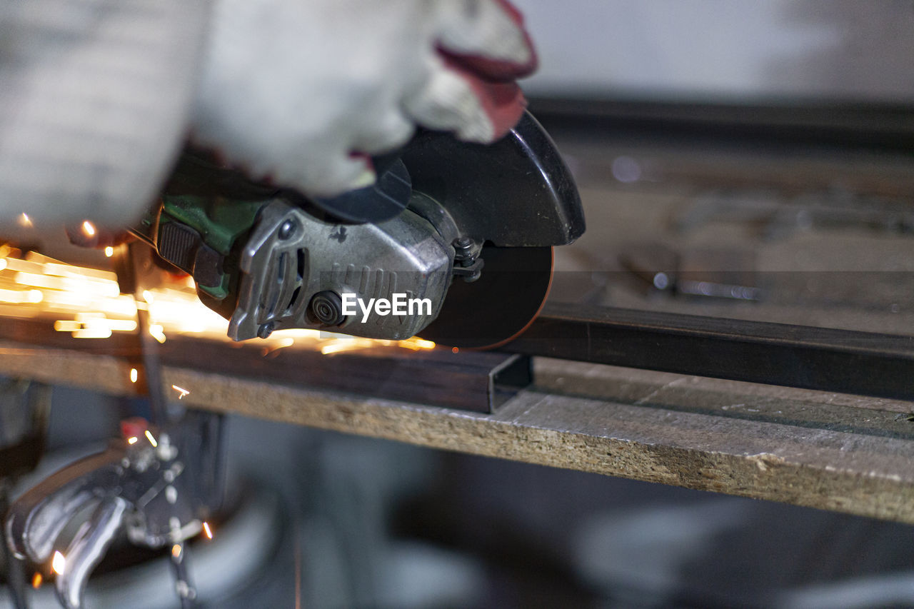 CLOSE-UP OF HAND WORKING ON METAL